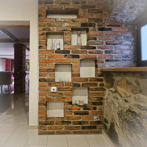a brick wall with four shelves on it at Jauki Lauki in Lejasciems
