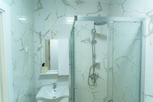 a bathroom with a shower and a sink at Modern apartment with terrace in Petrovec in Petrovec