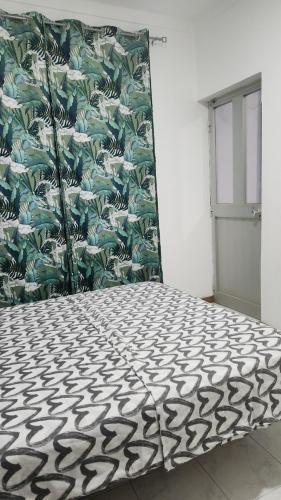 a room with a black and white patterned floor at Meeting Point Hostels-Praia Beachwalk-NO CASH ACCEPTED-Also in Fogo & Tarrafal in Praia