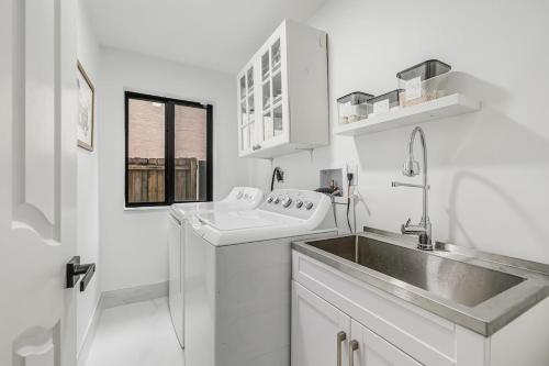a white kitchen with a sink and a sink at Modern Miami Home with Patio and Pool in Country Walk