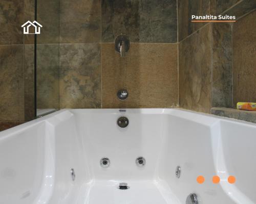 a white bath tub in a bathroom at PanaltitaSuites in Cancún