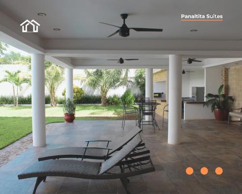 a covered patio with a bench and a table at PanaltitaSuites in Cancún