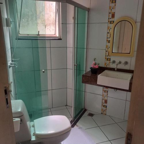 a bathroom with a toilet and a sink at Pousada do Bosque in Rio Branco