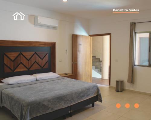 a bedroom with a large bed in a room at PanaltitaSuites in Cancún