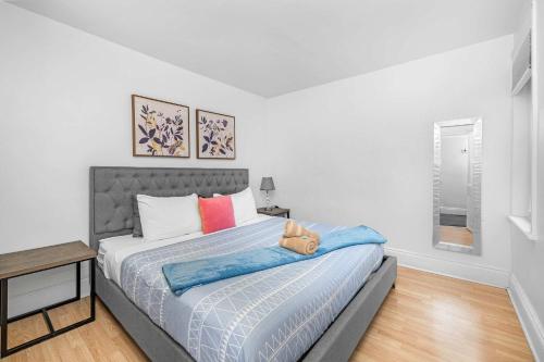 a bedroom with a large bed with a blue blanket at Urban 3BR Getaway Walk to ByWard Market- UOttawa in Ottawa