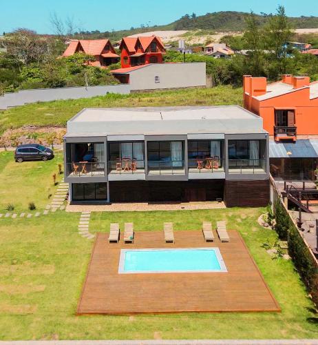 an aerial view of a house with a swimming pool at Pousada Austral Suítes in Imbituba