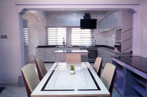 a kitchen with a table and chairs in a room at Nafik Suites in Rayfield