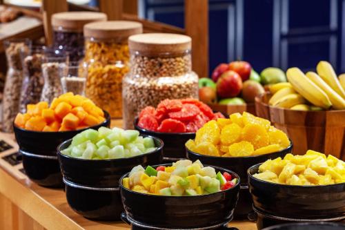 a buffet of fruits and vegetables in bowls on a counter at Hamburg Marriott Hotel in Hamburg