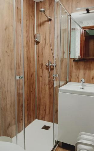 a bathroom with a shower and a sink at Hostal La Sierra Cabárceno in Sarón