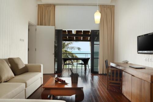 a living room with a couch and a table at Turi Beach Resort in Nongsa