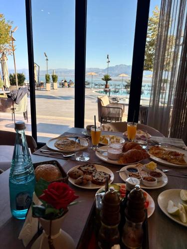 a table with plates of food and drinks on it at Duomo Resort in Shkodër