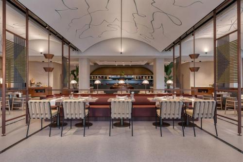 a dining room with a large table and chairs at The Landmark Nicosia, Autograph Collection in Nicosia
