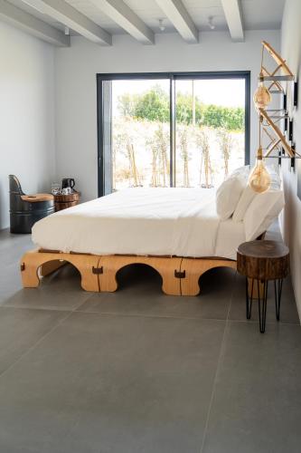 a bedroom with a wooden bed with a large window at B&B Panevì in San Marcello