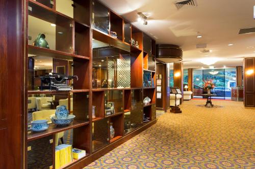 a library with wooden shelves filled with books at Royal On The Park in Brisbane
