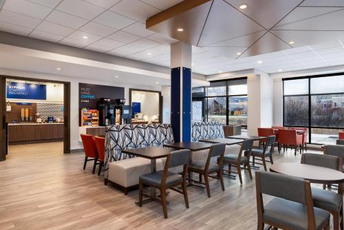 a restaurant with tables and chairs and a counter at Holiday Inn Express & Suites Steamboat Springs by IHG in Steamboat Springs
