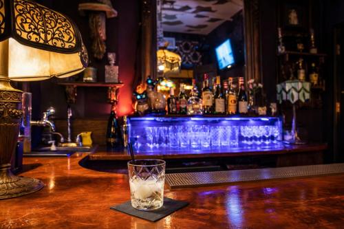 a bar with a glass sitting on a bar counter at The Rosemary in Los Angeles