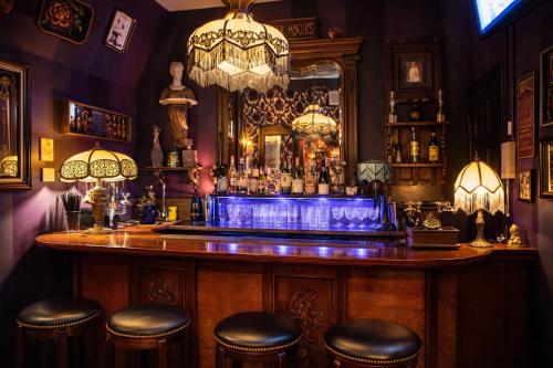 a bar in a pub with a mirror and stools at The Rosemary in Los Angeles