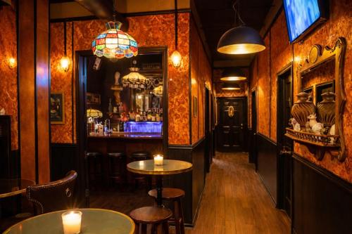 a pub with two tables and a bar with candles at The Rosemary in Los Angeles