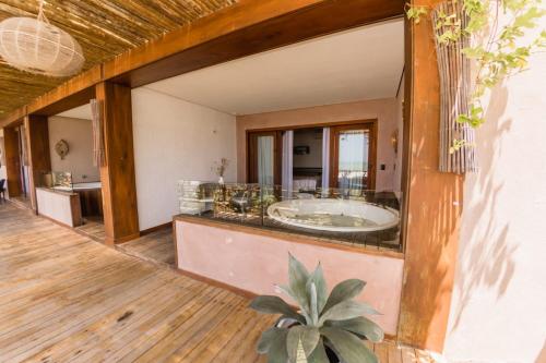 a large bathroom with a tub in a room at Carlore Hotel Taíba in Taíba