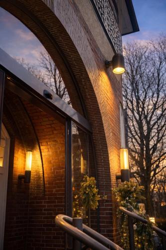 a brick building with a window with lights on it at Sleephotels Suite Garde in Hamburg