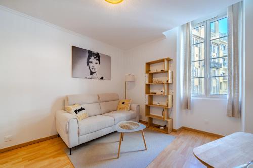 ein Wohnzimmer mit Sofa und Tisch in der Unterkunft Charming 2P ideally located - Garibaldi & Port in La Celle-sous-Gouzon