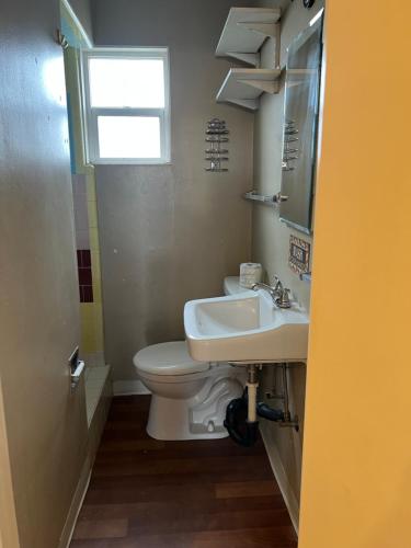 a bathroom with a toilet and a sink at Lariat Motel in Sparks