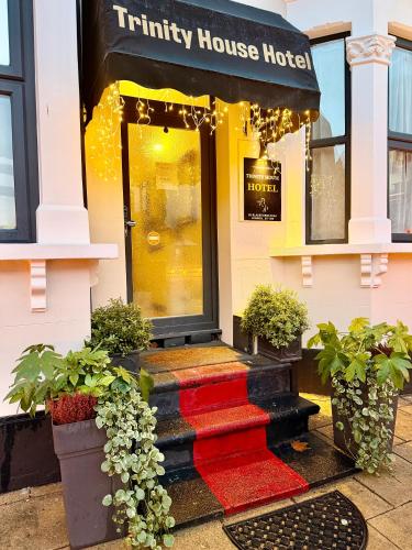 a entry to a trinity house hotel with potted plants at Trinity House Hotel in London
