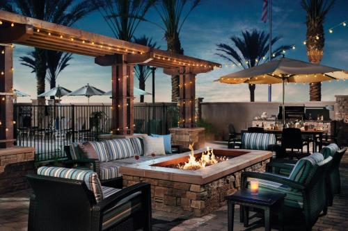 a patio with a fire pit and tables and chairs at Residence Inn by Marriott Battle Creek in Battle Creek