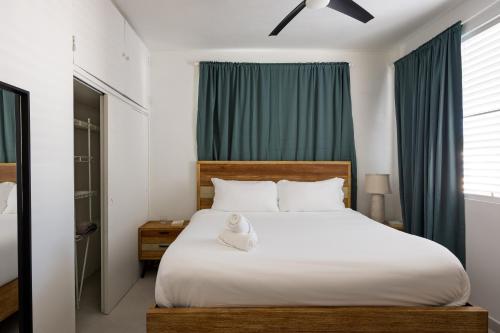 a bedroom with a bed with a teddy bear on it at Ocean Park 3BDR 2b Hot tub-Terrace Riviera Villa in San Juan
