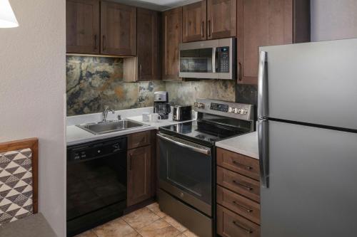 a kitchen with a refrigerator and a sink at Marriott's Mountain Valley Lodge at Breckenridge in Breckenridge