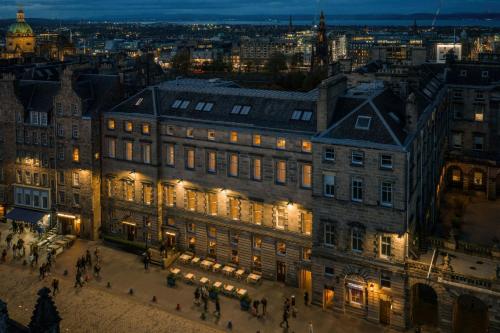 a large building in a city at night at Old Town Chambers, Autograph Collection in Edinburgh