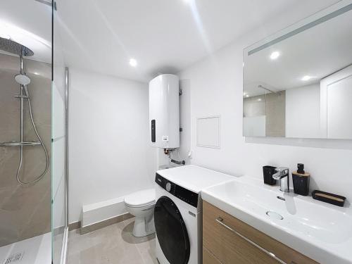 un bagno bianco con un water e un lavandino di Le BEAU LOUIS a Lione