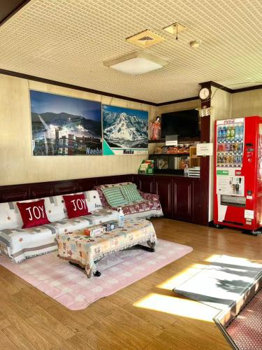 a living room with a couch and a coffee table at 苗場ウッドインだいまる in Yuzawa