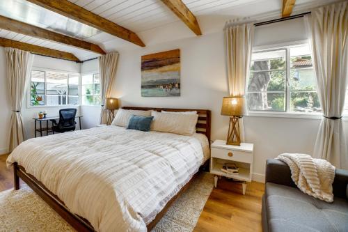 a bedroom with a large bed and two windows at Spacious Riverside Farmhouse, Perfectly Located in Edgemont