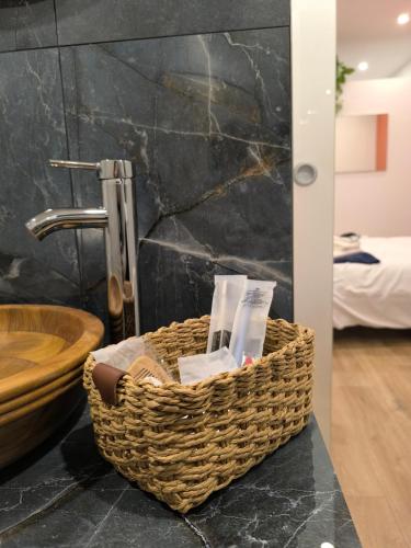 a basket of toiletries on a counter in a bathroom at Casa con vista in Ariccia