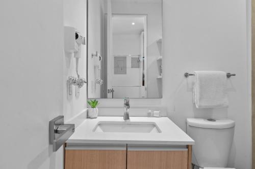 a white bathroom with a sink and a toilet at Modern Ocean View Apartment Private Balcon in Nuevo Nayarit