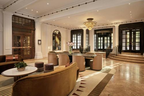 a dining room with a table and chairs at Sheraton Grand London Park Lane in London