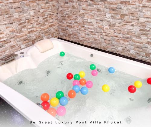a bath tub filled with balloons in a room at Luxury Pool Villa 5 mins to Phuket Old Town in Ban Lo Long