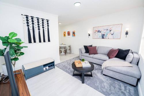 a living room with a couch and a table at Close to the Action, Peaceful When You Return in Orlando