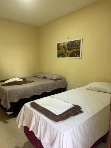 En eller flere senge i et værelse på Pousada Santa terezinha