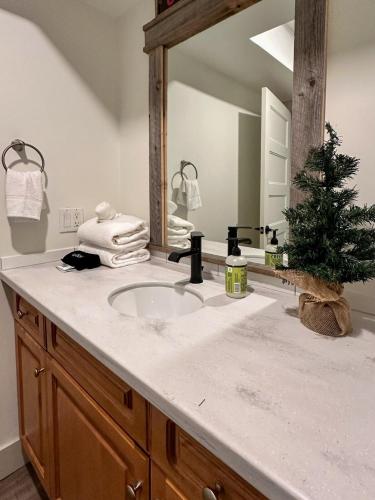 a bathroom with a sink with a christmas tree on it at Beautiful tranquil centrally located condo in Collingwood
