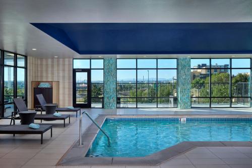 a large swimming pool in a hotel lobby with windows at Fairfield Inn & Suites by Marriott Denver Downtown in Denver