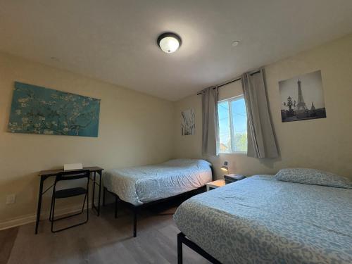 a small room with two beds and a window at Blue Private Room near BMO Stadium USC and K-Town in Los Angeles