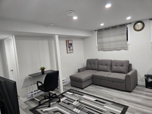 a living room with a couch and a chair at 2705 B Makowsky Crescent, Regina in Regina