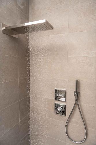 a shower with a shower head in a bathroom at Apartments in Pieve di Ledro - Ledrosee 22645 in Ledro
