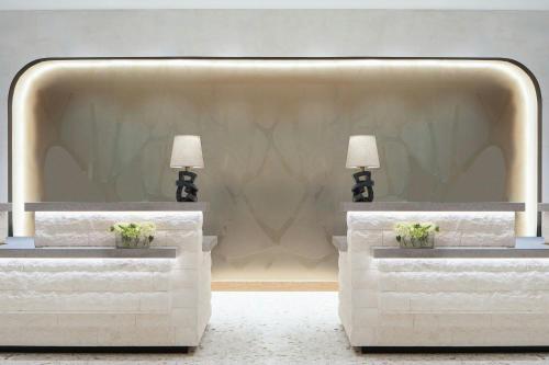 two tables in a room with two lamps on them at The Westin Galleria Dallas in Dallas