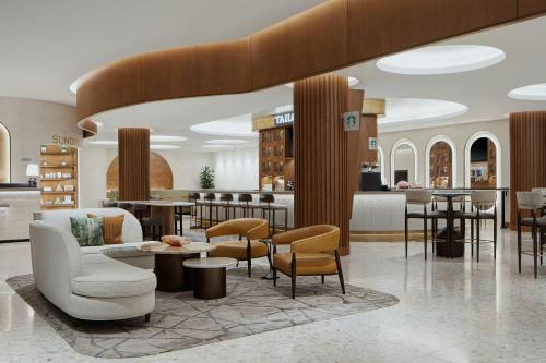 a lobby of a hotel with tables and chairs at The Westin Galleria Dallas in Dallas