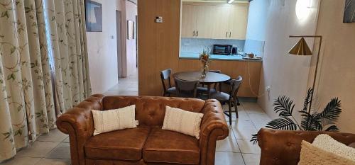 a living room with a couch and a table at Heart of Townsville tranquillity in Ross River