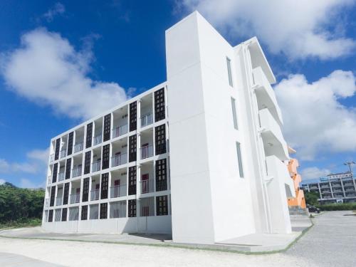 a white building with windows on the side of it at コンドミニオ宮古空港 in Miyako-jima