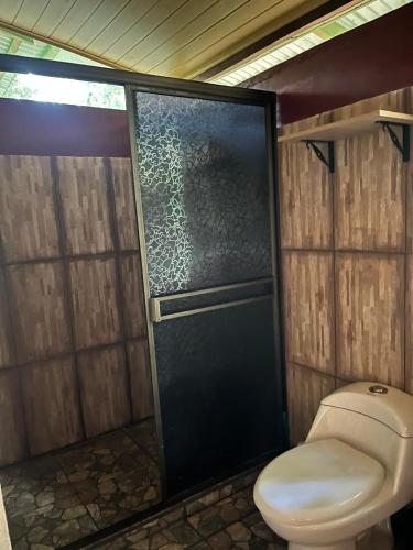 a bathroom with a toilet and a shower at Tekuna in Leticia